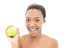 Smiling beauty holding green apple on white background