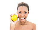 Smiling beautiful model holding orange on white background