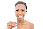 Beautiful smiling model holding glass of milk on white background