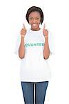 Happy volunteer giving thumbs up on white background