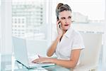 Stylish businesswoman talking on the phone at home