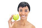 Content black haired woman holding an apple on white background