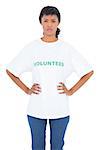 Irritated black haired volunteer posing with hands on the hips on white background