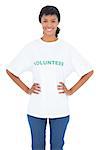 Content black haired volunteer posing with hands on the hips on white background