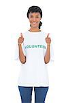 Charming black haired volunteer giving thumbs up on white background
