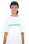 Content black haired volunteer posing looking at camera on white background