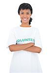 Content black haired volunteer posing with crossed arms on white background