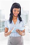 Stylish businesswoman using a tablet pc in office