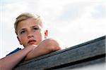 Close-up portrait of boy outdoors, looking into the distance, Germany