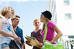 Group of teenagers standing outdoors talking, Germany