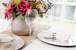 Elegant table setting at wedding event with plate charger and napkin