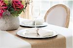 Elegant table setting at wedding event with plate charger and napkin