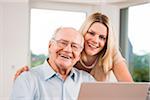 Young Woman with Senior Man using Laptop at Home, Mannheim, Baden-Wurttemberg, Germany