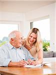 Young Woman and Senior Man looking at Document, Mannheim, Baden-Wurttemberg, Germany