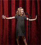 USA, Utah, Orem, Portrait of girl (8-9) singing with microphone