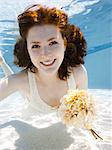 USA, Utah, Orem, Portrait of young woman with bouquet under water