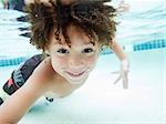 USA, Utah, Orem, Boy (4-5) swimming in pool