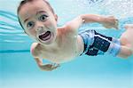 USA, Utah, Orem, Boy (6-7) swimming in pool