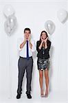 Portrait of surprised young couple at party