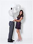 Young couple with balloons at party