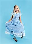 Portrait of girl (10-11) in Alice in Wonderland costume for Halloween