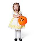 Girl (2-3) in Goldilocks costume with pumpkin lantern for Halloween