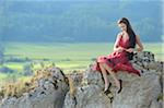 Portrait of Young Woman Sitting on Rocks, Upper Palatinate, Bavaria, Germany