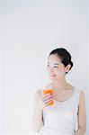 Young woman with vegetable juice smiling away