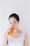 Young woman drinking vegetable juice