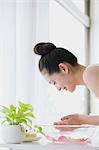 Young woman washing face