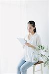 Young woman sitting with tablet in the living room