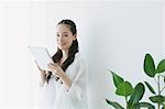 Young woman sitting with tablet in the living room