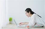 Young woman with laptop in the living room