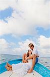 Man and woman embracing in bow of boat