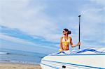 Woman on beach with paddle board