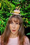 Woman with birthday cupcake on head