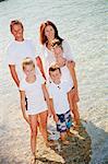 Family standing in shallow water