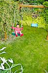 Boy on backyard swing