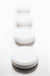 Pills in row on white background