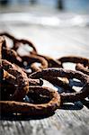 Close-up of rusty chain on jetty