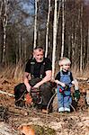 Grandfather with grandson in forest