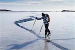 Person skating at frozen sea