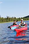 Women kayaking on lake