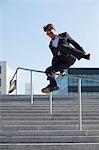 Businessman Jumping Over Outdoor Banister,  Munich, Bavaria, Germany