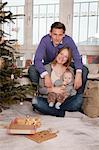 Parents with baby alongside Christmas tree, Munich, Bavaria, Germany