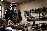 Blacksmith working in shop, Landshut, Bavaria, Germany