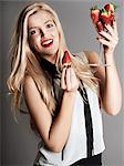 Pretty blonde girl holding glass of Strawberries