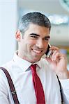 Close-up of businessman smiling on mobile phone
