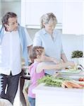 Family making a healthy salad in the kitchen