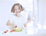 Young girl making a salad